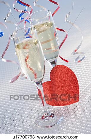 Flutes with champagne and red paper heart, close-up View Large Photo Image Stock Image - Flutes with champagne and red paper heart, close-up. Fotosearch
