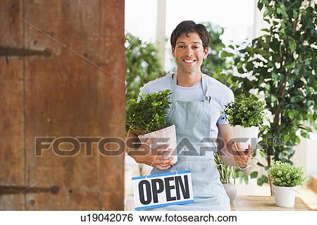 Stock Photograph - Gardener inPlant Shop. Fotosearch