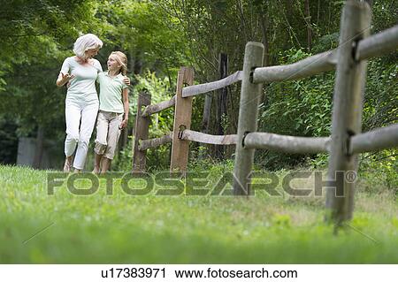 Girl (10-11) and grandmother walking together View Large Photo Image Stock Image - Girl (10-11) and grandmother walking together. Fotosearch