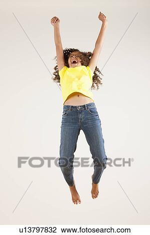 Girl (10-11) jumping, studio shot View Large Photo Image Stock Image - Girl (10-11) jumping, studio shot. Fotosearch