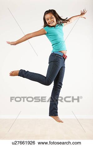 Girl (10-11) jumping, studio shot View Large Photo Image Stock Photograph - Girl (10-11) jumping, studio shot. Fotosearch