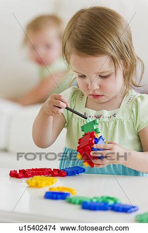 Girl (2-3) playing with colorful toys View Large Photo Image Picture - Girl (2-3) playing with colorful toys. Fotosearch