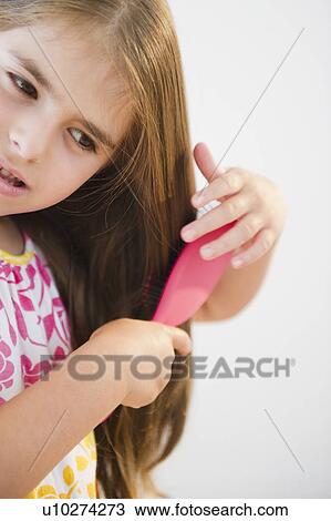 Girl ( 6-7) brushing hair View Large Photo Image Stock Image - Girl ( 6-7) brushing hair. Fotosearch