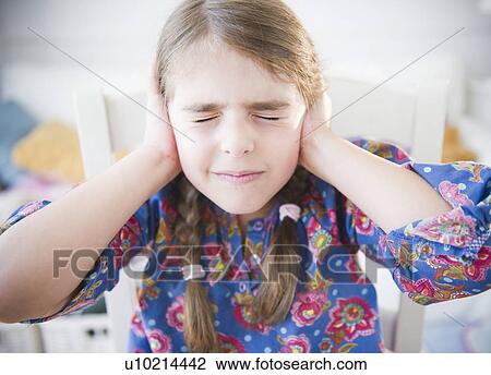 Stock Image - Girl ( 6-7) covering ears. Fotosearch