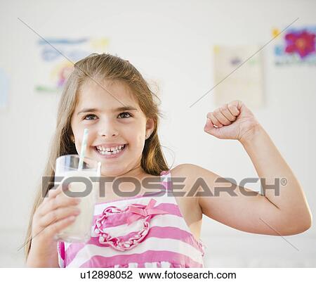 Girl ( 6-7) drinking milk and showing strength View Large Photo Image Stock Image - Girl ( 6-7) drinking milk and showing strength. Fotosearch