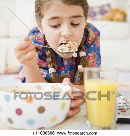 Girl ( 6-7) eating cereals View Large Photo Image Stock Photograph - Girl ( 6-7) eating cereals. Fotosearch
