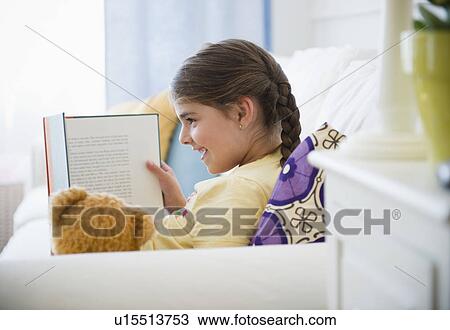 Girl ( 6-7) reading onSofa View Large Photo Image Stock Image - Girl ( 6-7) reading onSofa. Fotosearch