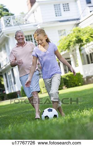 Grandfather and granddaughter (10-11) playing soccer View Large Photo Image Stock Photograph - Grandfather and granddaughter (10-11) playing soccer. Fotosearch