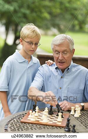 Grandfather teaching grandson (10-11) how to play chess View Large Photo Image Stock Image - Grandfather teaching grandson (10-11) how to play chess. Fotosearch