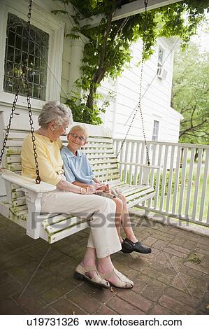 Grandmother and grandson (10-11) sitting on porch swing View Large Photo Image Stock Photograph - Grandmother and grandson (10-11) sitting on porch swing. Fotosearch