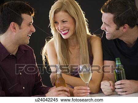 Stock Photography - Group of friends drinking in nightclub. Fotosearch