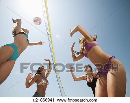 Group of young women playing beach volleyball View Large Photo Image Stock Image - Group of young women playing beach volleyball . Fotosearch