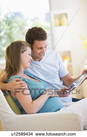 Happy parents watching ultrasound picture of baby View Large Photo Image Picture - Happy parents watching ultrasound picture of baby. Fotosearch