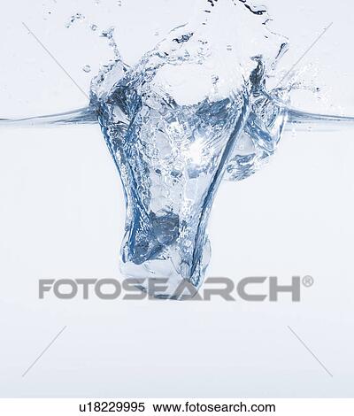 Ice cube splashing into water, studio shot View Large Photo Image Stock Photography - Ice cube splashing into water, studio shot. Fotosearch