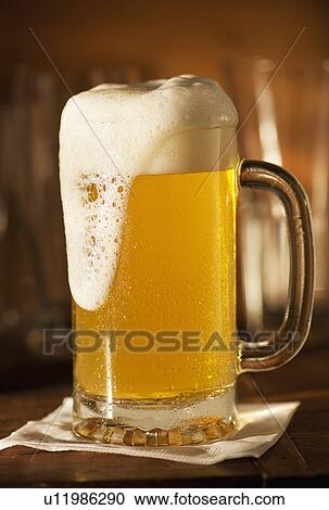 Lager in beer glass on bar counter View Large Photo Image Stock Image - Lager in beer glass on bar counter. Fotosearch