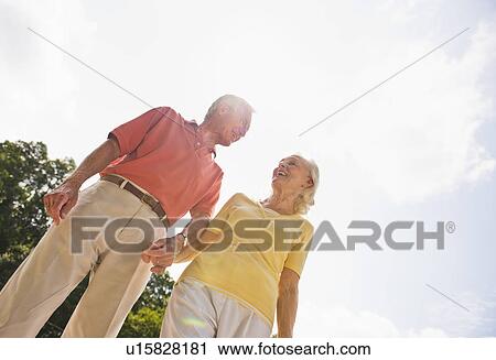 Stock Image - Low angle view of Senior couple. Fotosearch
