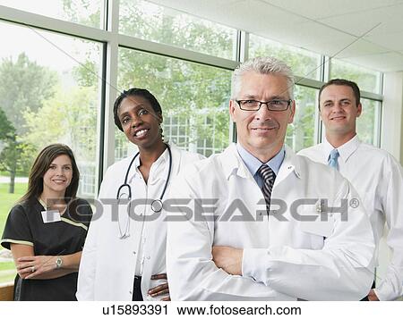 Male and female doctor, hospital manager and nurse posing for portrait View Large Photo Image Stock Image - Male and female doctor, hospital manager and nurse posing for portrait. Fotosearch