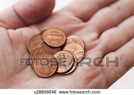 Stock Photograph - Male hand holding coins. Fotosearch