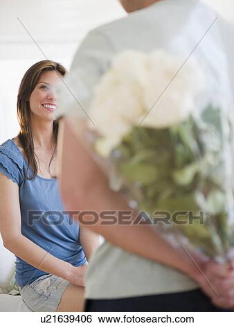Man bringing bouquet to woman View Large Photo Image Stock Photograph - Man bringing bouquet to woman. Fotosearch