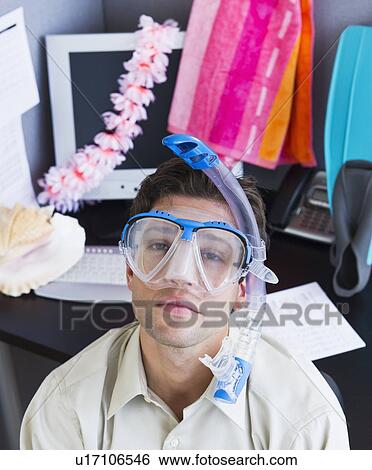 Stock Photograph - Man wearing scubamask in office. Fotosearch