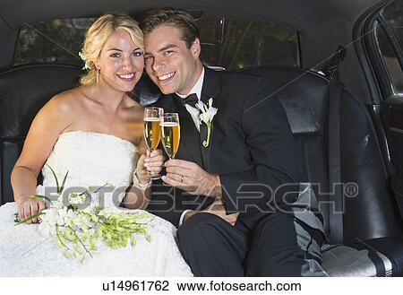 Stock Image - Married couple in limousine. Fotosearch