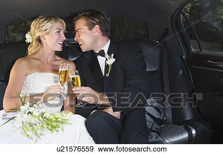 Stock Photo - Married couple in limousine. Fotosearch