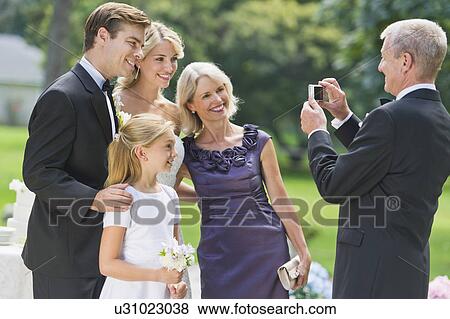 Married couple, parents and flower girl (10-11) posing View Large Photo Image Stock Photo - Married couple, parents and flower girl (10-11) posing. Fotosearch
