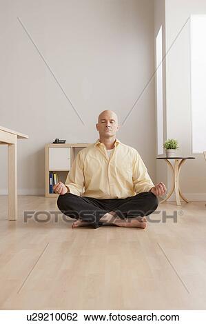 Mature businessman meditating in office View Large Photo Image Stock Image - Mature businessman meditating in office. Fotosearch