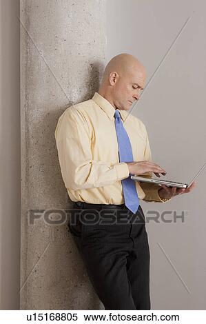 Mature businessman using laptop View Large Photo Image Stock Photography - Mature businessman using laptop. Fotosearch