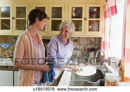 Mother and adult daughter washing dishes View Large Photo Image Stock Photo - Mother and adult daughter washing dishes. Fotosearch