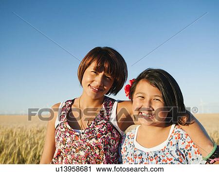 Mother and daughter (10-11) standing in wheat field View Large Photo Image Stock Image - Mother and daughter (10-11) standing in wheat field . Fotosearch