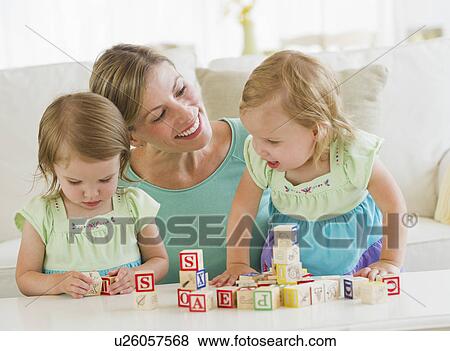 Mother and daughters (2-3) playing with letter blocks View Large Photo Image Stock Photo - Mother and daughters (2-3) playing with letter blocks. Fotosearch