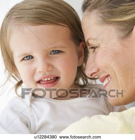 Stock Image - Mother holding daughter (2-3). Fotosearch