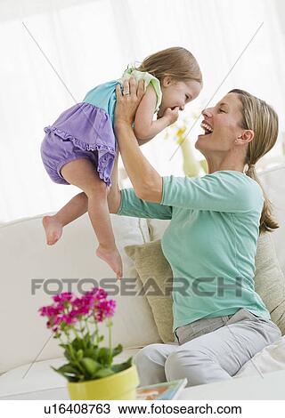 Mother playing with daughter (2-3) on sofa View Large Photo Image Stock Image - Mother playing with daughter (2-3) on sofa. Fotosearch