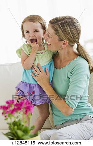 Mother playing with daughter (2-3) on sofa View Large Photo Image Stock Photography - Mother playing with daughter (2-3) on sofa. Fotosearch