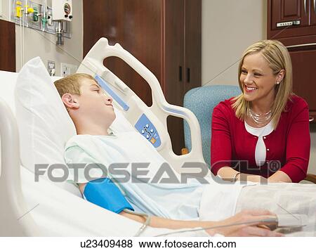 Mother visiting son (10-11) in hospital View Large Photo Image Stock Photo - Mother visiting son (10-11) in hospital. Fotosearch
