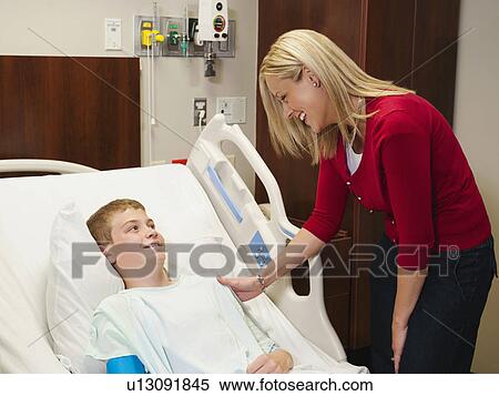 Stock Photography - Mother visiting son (10-11) in hospital. Fotosearch