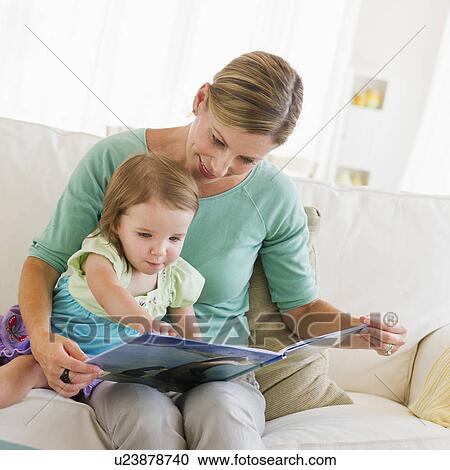 Mother with daughter (2-3) reading book on sofa View Large Photo Image Stock Image - Mother with daughter (2-3) reading book on sofa. Fotosearch
