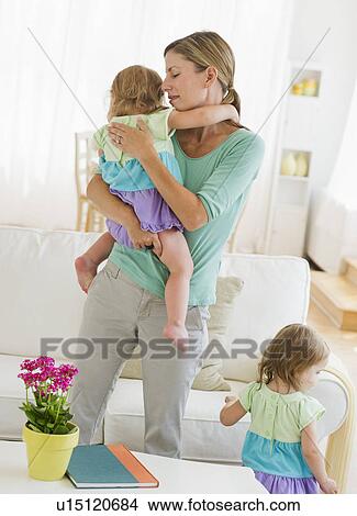 Mother with daughters (2-3) in living room View Large Photo Image Picture - Mother with daughters (2-3) in living room. Fotosearch