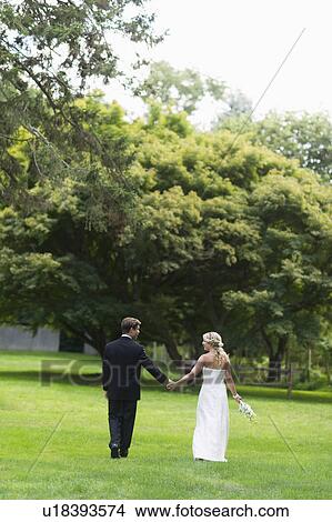 Newly wed couple walking together View Large Photo Image Picture - Newly wed couple walking together. Fotosearch