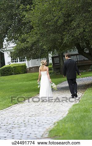 Picture - Newly wed couple walking together. Fotosearch