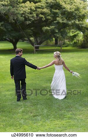Stock Image - Newly wed couple walking together. Fotosearch