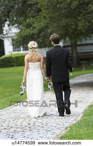 Newly wed couple walking together View Large Photo Image Stock Photo - Newly wed couple walking together. Fotosearch