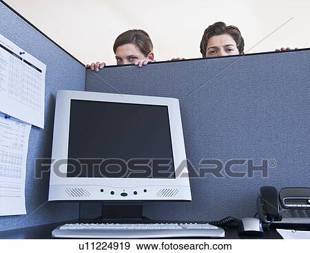 Stock Photo - Office workers hiding behind cubicle wall. Fotosearch