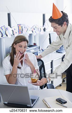 Stock Image - Officeworkers celebrating birthday. Fotosearch