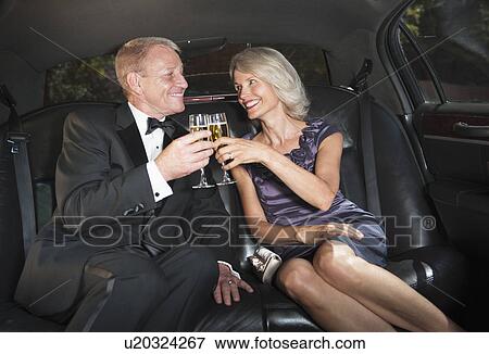 Parents of bride drinking champagne inside limousine View Large Photo Image Stock Photo - Parents of bride drinking champagne inside limousine. Fotosearch