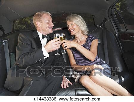 Parents of bride drinking champagne inside limousine View Large Photo Image Stock Photograph - Parents of bride drinking champagne inside limousine. Fotosearch