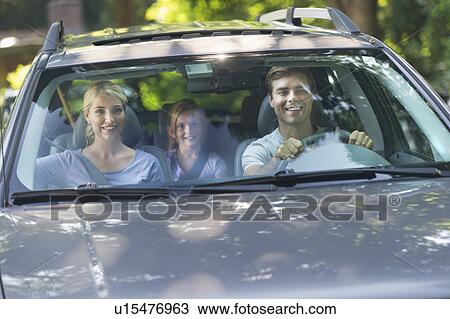 Parents with daughter (10-11) driving car View Large Photo Image Stock Image - Parents with daughter (10-11) driving car. Fotosearch