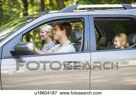 Parents with daughter (10-11) driving car View Large Photo Image Stock Photo - Parents with daughter (10-11) driving car. Fotosearch