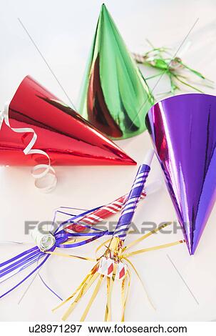 Party horn blowers and paper party hats View Large Photo Image Stock Photo - Party horn blowers and paper party hats. Fotosearch